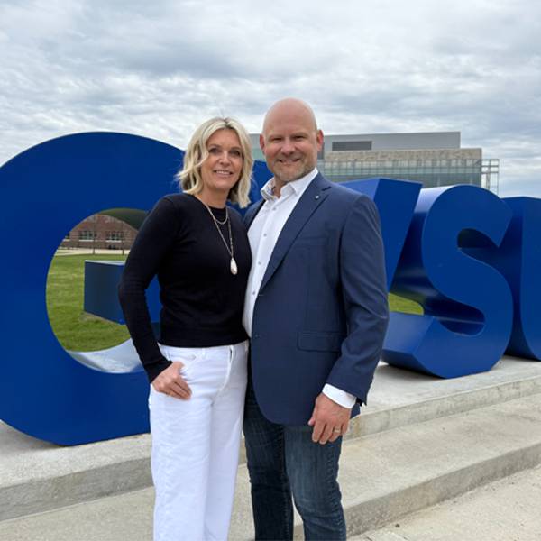 Photo of the Herremas in front of the GVSU sign